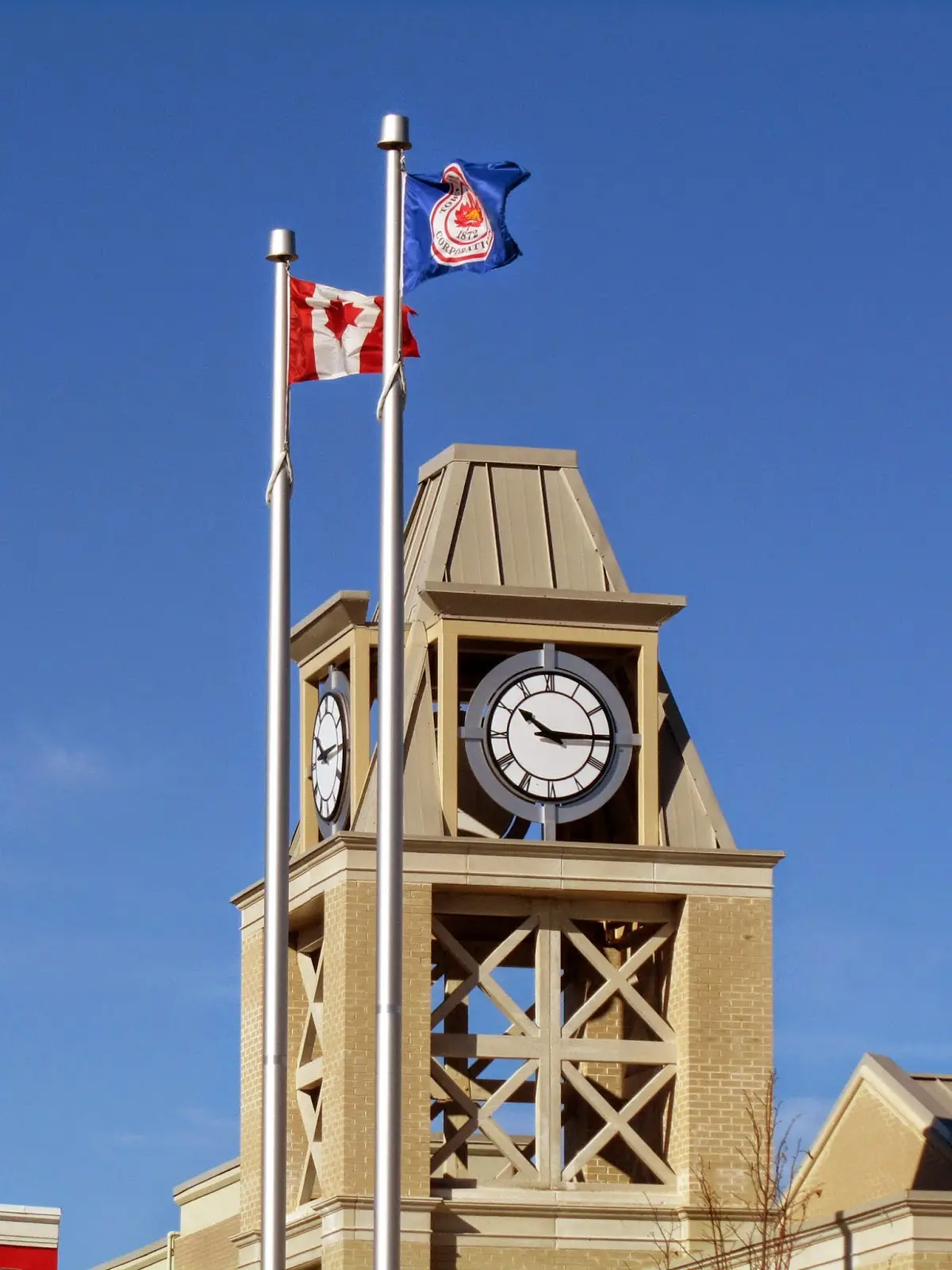 a clock tower with a flag and a flag